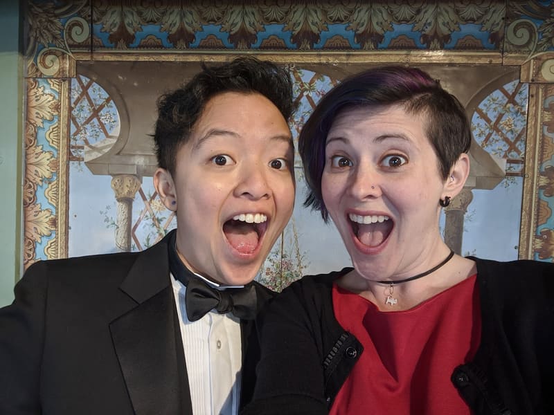 Holly and Rosalie in formalwear making wide-eyed faces
